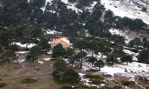 Panorámica invernal del refugio del Pozo de la Nieve en su entorno entre los Prados del Rey y el pie del Collado de La Boleta.